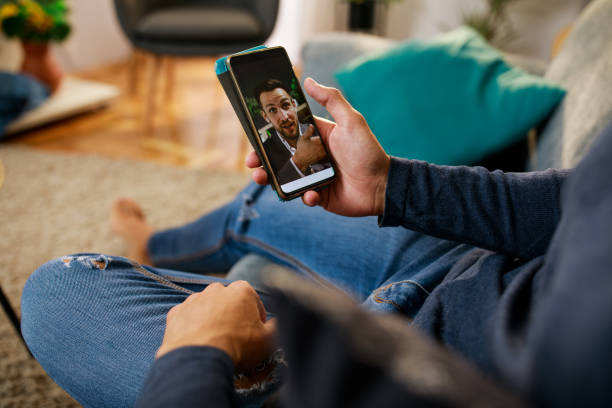 istock Unrecognizable young man video chatting with a friend 1347323901