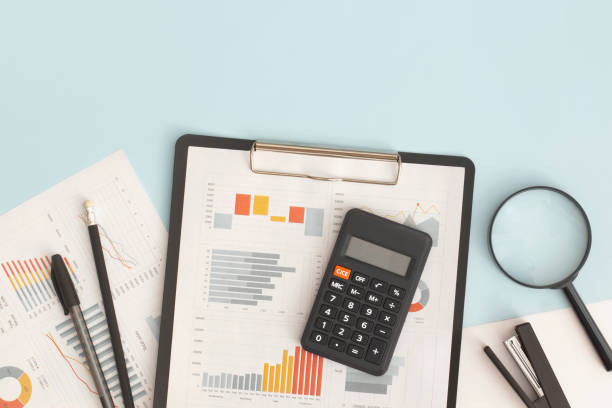 Business graphs, charts, magnifying glass and calculator on table. Financial development, Banking Account, Statistics Business graphs, charts, magnifying glass and calculator on table. Financial development, Banking Account, Statistics accountancy stock pictures, royalty-free photos & images