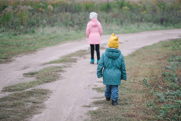 istock Children play in the field running from flying drone 1347324949