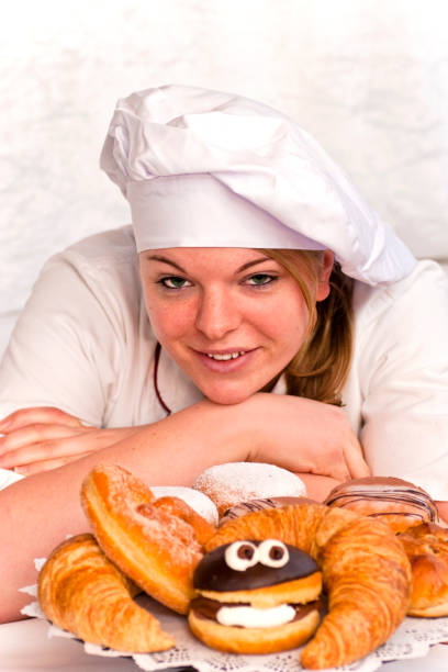 Young female baker with selection of her creations