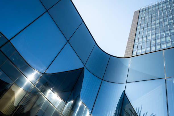 istock Curvy glass arch wall and skyscraper 1347328995
