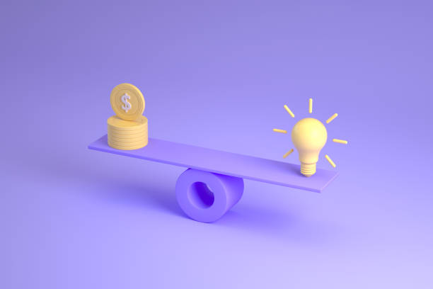 istock Light bulb vs Us coin on balance board 1347329051