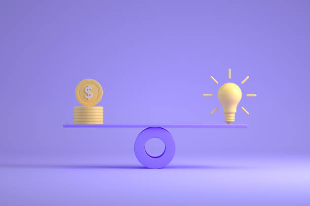 istock Light bulb vs Us coin on balance board 1347329094