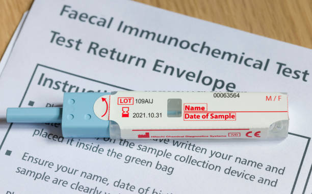 FIT test, stool test for bowel cancer screening UK - April 21, 2021. Closeup of FIT test (faecal immunochemical test), a fecal occult blood test for screening bowel cancer specimen holder stock pictures, royalty-free photos & images