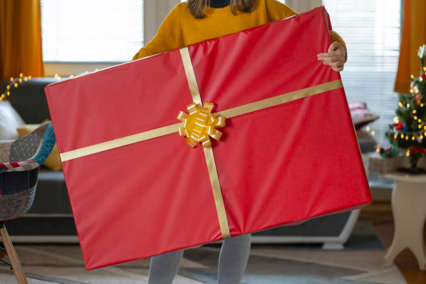 istock Holding with both hands a very large Christmas gift 1347331196