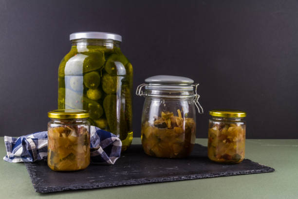 istock Batch of home made marrow chutney jars and pickled gherkins, landscape, copyspace. 1347332903