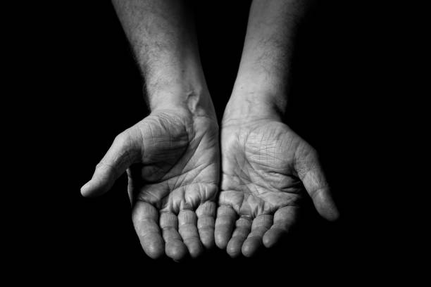 istock Male hands held out, with palms up begging. 1347333852