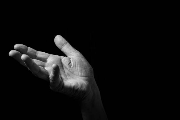 istock Male hand held out, gesturing with palm up. 1347333863