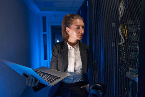 istock Pretty woman working in internet server room 1347338288