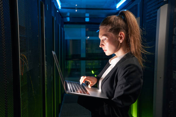 istock Caucasian attractive woman use laptop in datacenter 1347338295