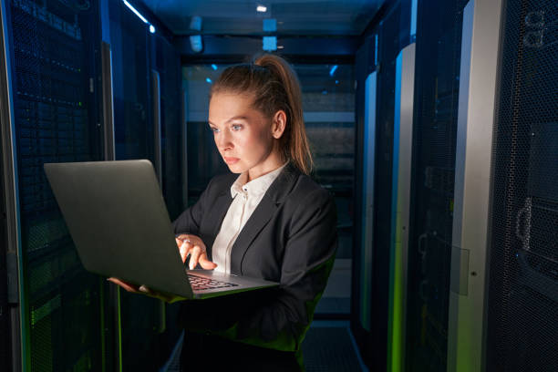 istock Young attractive woman working in server room 1347338298