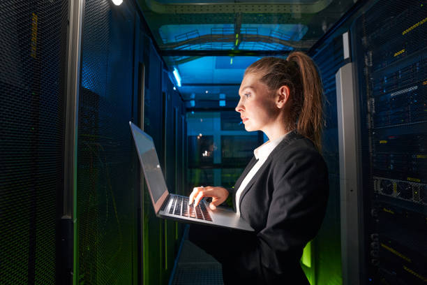 istock Adult woman network engineer in server room 1347338310