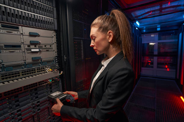istock Side view of female network engineer in server room 1347338324