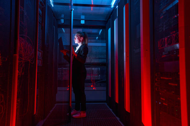 istock Engineer businesswoman works in network server room 1347338366