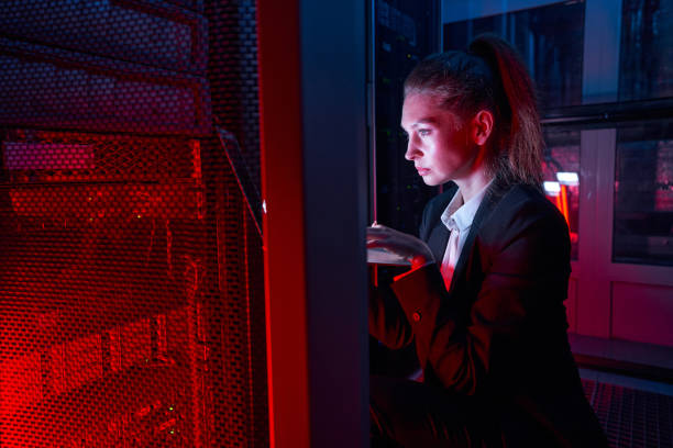 istock Woman administrator checking equipment in data center 1347338378