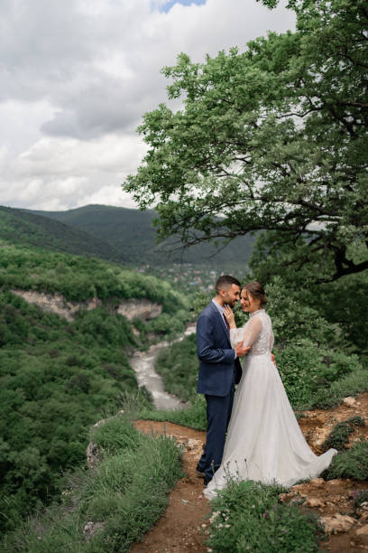 istock a beautiful hugging newlyweds in a wedding ceremony in the mountains 1347339332