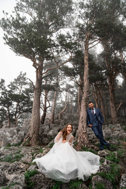 istock fun bride and groom in a mysterious misty mountain forest. honeymoon 1347339721