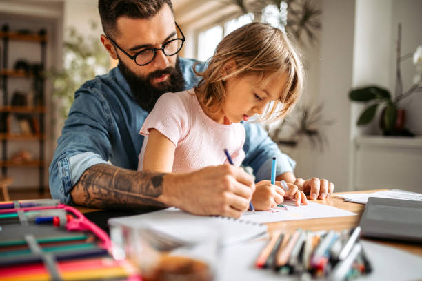 istock Daughter and father doing homework together 1347340009