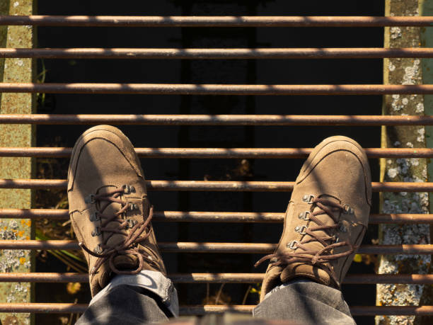 istock suede boots top view stand on an iron bridge over an abyss 1347341583