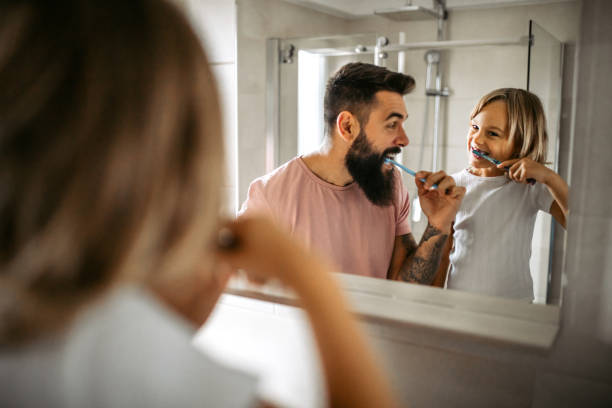istock Father and daughter brushing teeth 1347342830