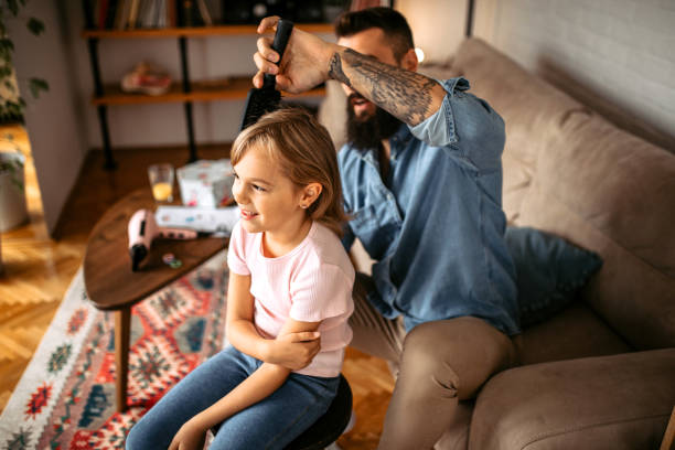 istock Young handsome father brushing daughter's hair 1347343015