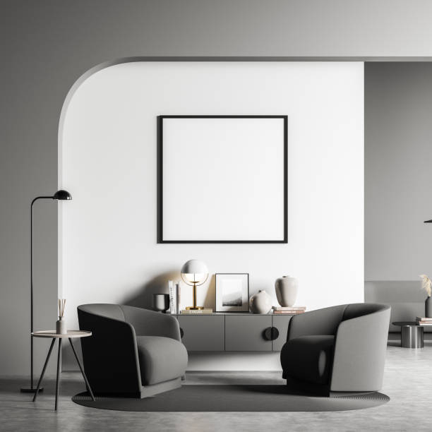 istock Living room seating and empty square frame on grey wall 1347345834