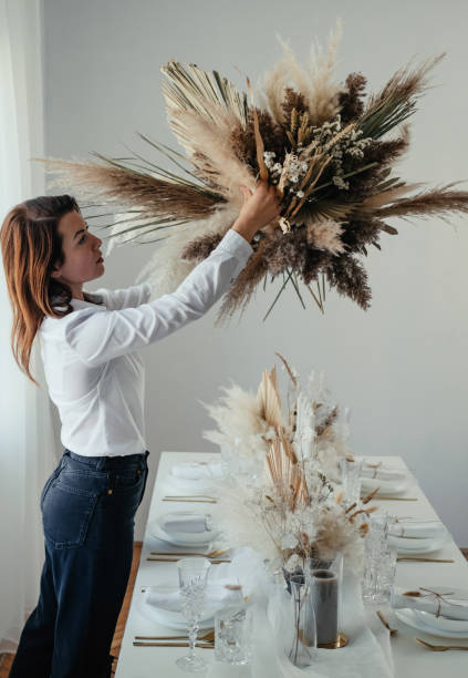 istock Beautiful Woman Decorating Home for Christmas Dinner 1347346608