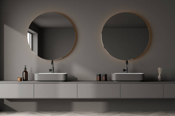 istock View of a grey bathroom wall hung double vanity with round mirrors 1347347982