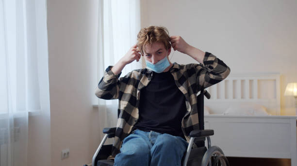 istock A young disabled man is putting on a mask on his face 1347349294