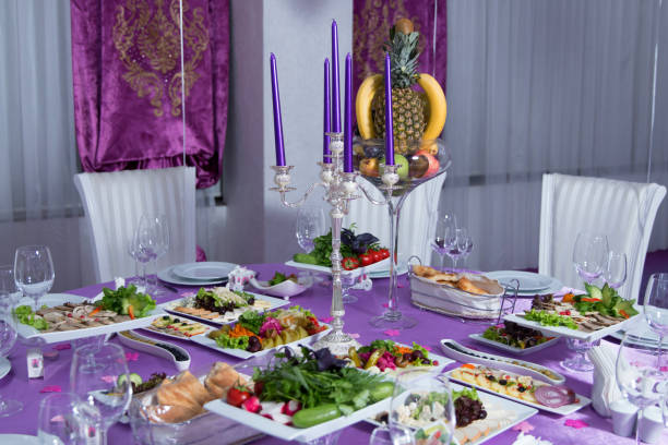 istock The elegant dinner table. Wedding table decorated with candles, served with cutlery and crockery and covered with a tablecloth . Pink tablecloth . White chairs . White wedding table. A table decorated with balloons. 1347350493