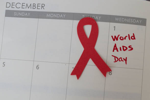 World AIDS Day on December 1st, 2021 World AIDS Day marked on the calendar for December 1st, 2021 with a red ribbon next to the date. world aids day stock pictures, royalty-free photos & images
