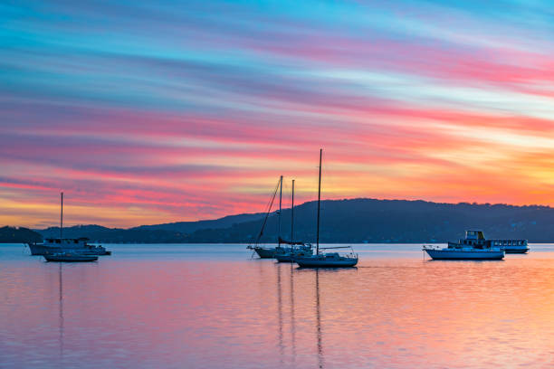 istock Sunrise waterscape with boats, reflections and high cloud 1347353370