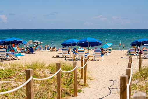Delray Beach, FL, USA - October 17, 2021: Blue umbrellas on the beach