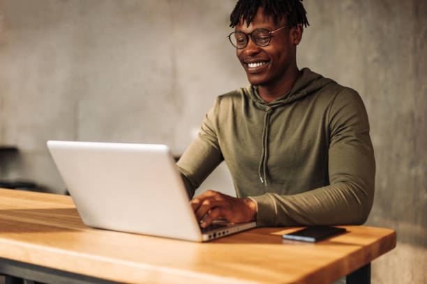 istock African man with laptop at the table. distance communication, training. online communication 1347366785