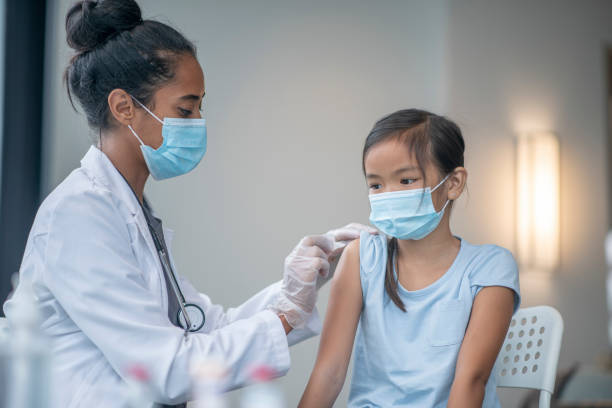 istock Doctor Placing a Bandage on a Patient after a Vaccination 1347369508