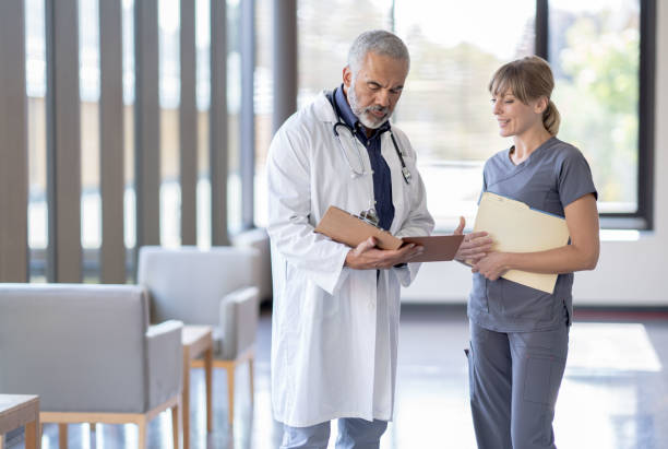 istock Doctor Reviewing a Case with a Nurse 1347369784
