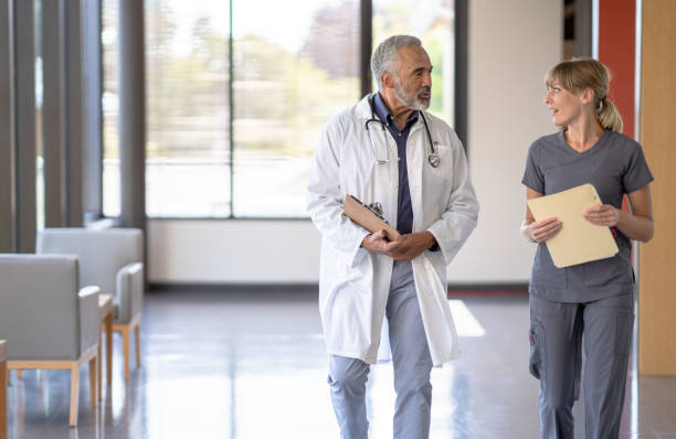 istock Nurse and Doctor Walking in the Hallway 1347369791