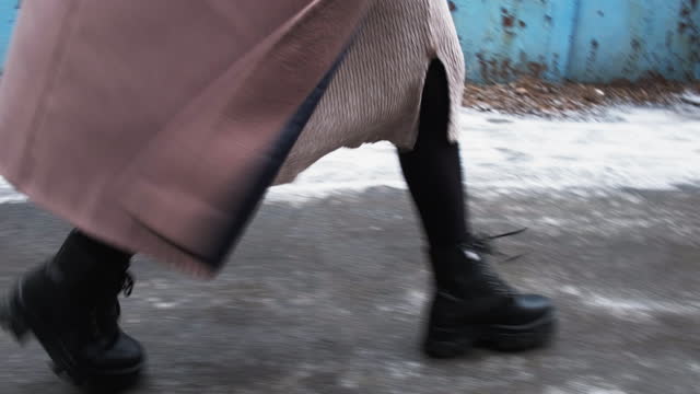 city walk outdoor activity woman legs boots street