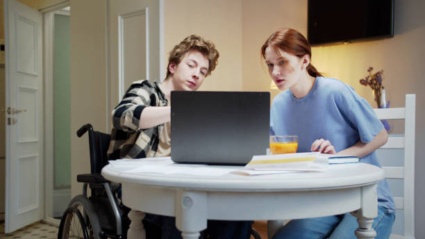 istock Two friends are discussing and watching something on the computer together 1347375154