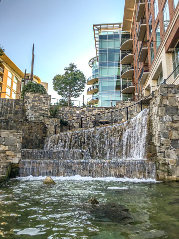 September 4,2021, Greenville, South Carolina. This walkway offers a peaceful setting to locals and visitors alike. As the sun sets on the city walking past a man made waterfall creates a peaceful setting.