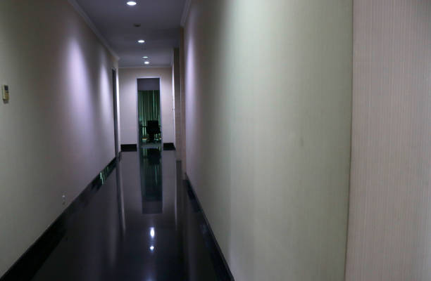 dim interior design of a hotel, with black floors and light brown walls