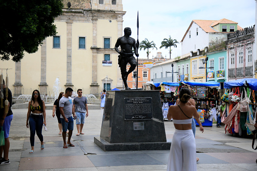 salvador, bahia, brazil - july 27, 2021: People are seen next to the sculpture of the black leader Zimbi dos Palmares in the Historic Center of the city of Salvador.