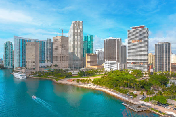 istock Iconic view of Miami skyline as seen from a drone with Bayfront park in frame and several high rises, palm trees, and big yacht 1347383120