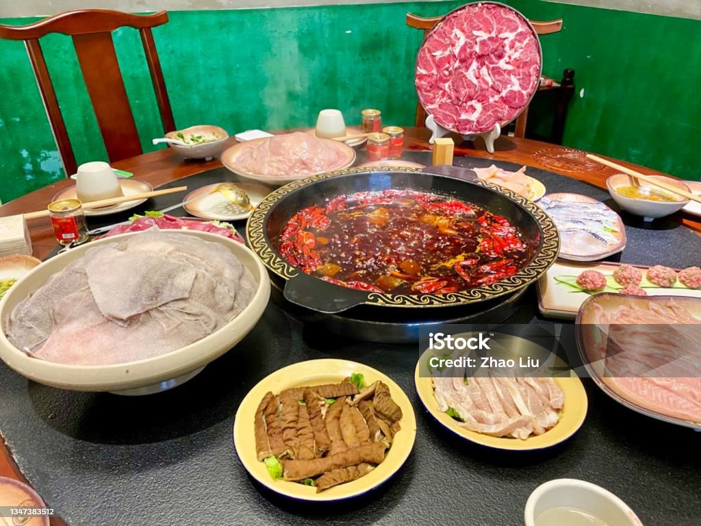 The Traditional Chongqing Spicy Hotpot, China Chongqing is one of the origin place of popular Chinese hotpot. Here are the images of traditional Chongqing Hotpot. The dishes includ beef, mutton, chicken, fish and edible animal organs. Chinese Culture Stock Photo