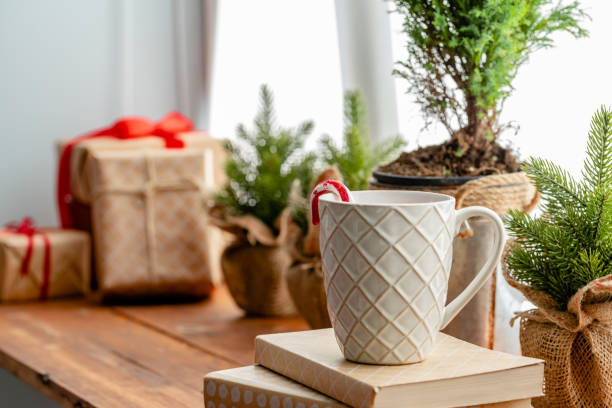 istock Christmas cane in a white cup on interior background 1347385012