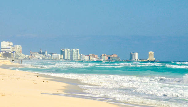 istock Beach scene with aqua blue water and white-capped waves and light colored sand 1347389007