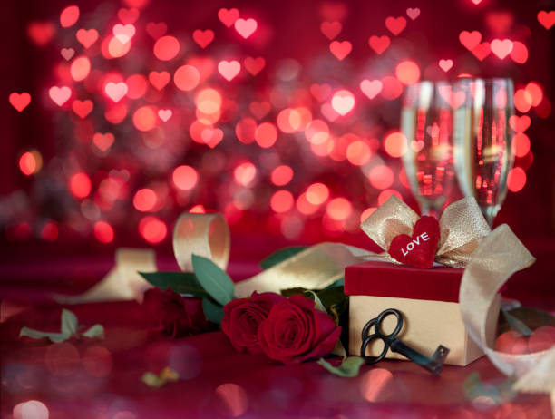 istock Valentine's Day Champagne and Red Roses on a Defocused Lights Background 1347392822