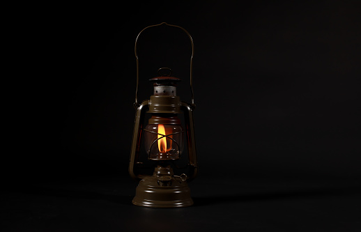 Old incandescent light bulb studio shot isolated on a black background.