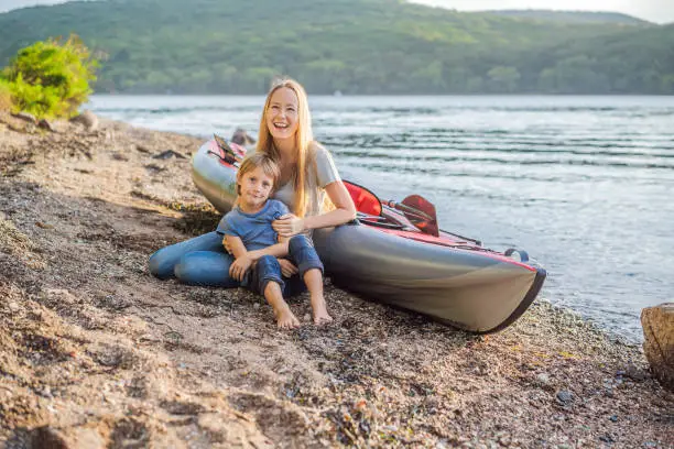 Happy mom and son are ready for kayaking.