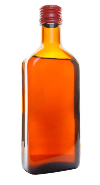 istock A beautiful glass bottle with a red lid is isolated on a white background. 1347398202